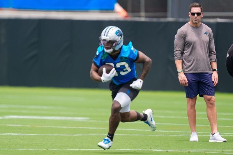 Jun 9, 2026; Charlotte, NC, USA;  Team Manager Dan Morgan watches running back Trevor Etienne (23) during the first day of mini camp at Bank of America Stadium practice facility. Mandatory Credit: Jim Dedmon-Imagn Images