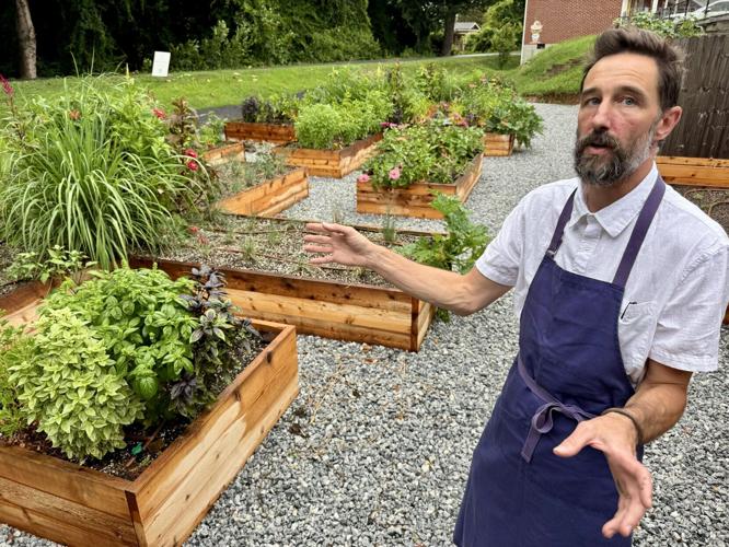 Chef Adam Cooke in his new trailside garden at Topsoil Kitchen & Market in Travelers Rest.