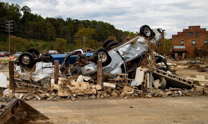 Vehicles lie amid the rubble Sept. 27, 2024, at Riverview Station in the River Arts District in Asheville, following the devastation of Tropical Storm Helene.