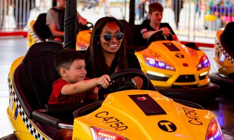 Esmeralda Trejo, right, and her son Ezekiel, 5, ride the bumper cars on opening weekend of the NC Mountain State Fair in Fletcher, Sept. 6, 2025.