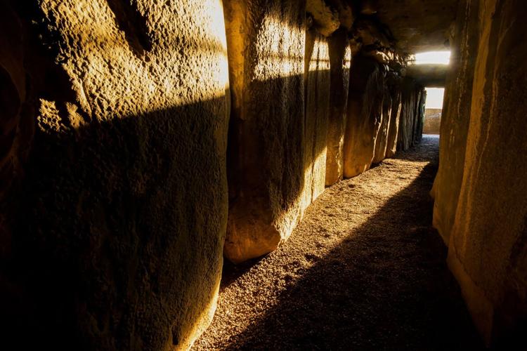 Sunlight streams into the passage of the Newgrange burial chamber.