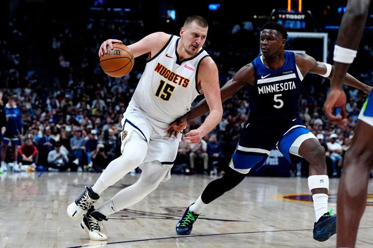 Denver Nuggets center Nikola Jokic (15) drives against Minnesota Timberwolves guard Anthony Edwards (5) during a game in Denver on Mar 12, 2025.