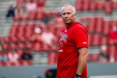 Sep 11, 2026; Raleigh, North Carolina, USA;  NC State Wolfpack head coach Dave Doeren looks on during the warmups of the game against Richmond Spiders at Carter-Finley Stadium.  Mandatory Credit: Jaylynn Nash-Imagn Images