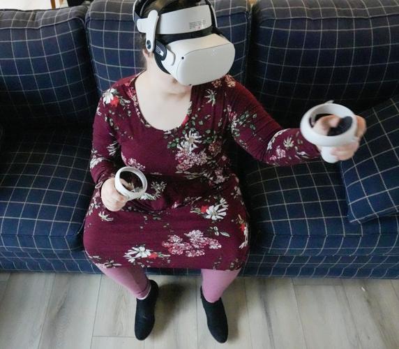 Gemma Firth uses a VR headset to create social connections from her home in New Berlin, Wisconsin, on Sunday, Dec. 10, 2023.