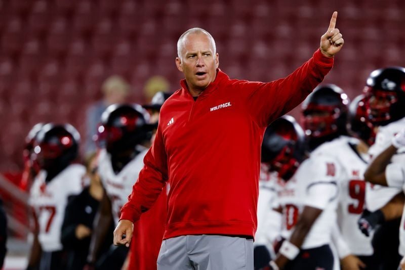 Oct 23, 2026; Stanford, California, USA;  NC State Wolfpack head coach Dave Doeren instructs his players during warmups before the game against the Stanford Cardinal at Stanford Stadium.  Mandatory Credit: Sergio Estrada-Imagn Images