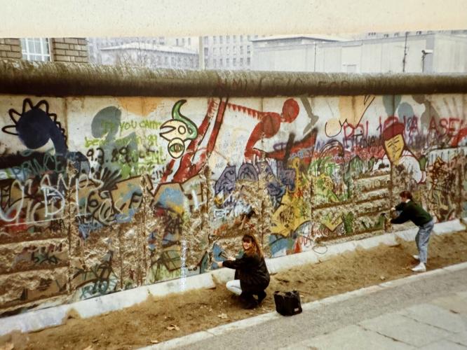 The writer, Lori Rackl, chips away at the Berlin Wall in 1989.