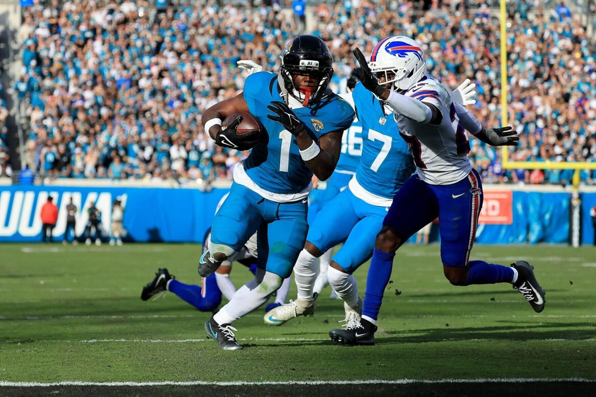 Travis Etienne Jr. of the Jacksonville Jaguars runs for a touchdown during the fourth quarter against the Buffalo Bills in the AFC Wild Card Playoff game at EverBank Stadium on Jan. 11, 2026, in Jacksonville, Florida.