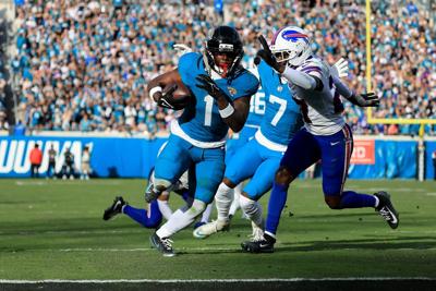 Travis Etienne Jr. of the Jacksonville Jaguars runs for a touchdown during the fourth quarter against the Buffalo Bills in the AFC Wild Card Playoff game at EverBank Stadium on Jan. 11, 2026, in Jacksonville, Florida.