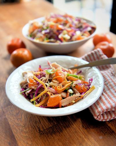 Chinese chicken salad features pulled rotisserie chicken, orange segments and cabbage in a tangy soy sauce-based dressing.
