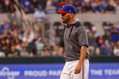 Texas Rangers manager Chris Woodward walks to the dugout during the eighth inning against the Atlanta Braves at Globe Life Field on April 30, 2022, in Arlington, Texas.