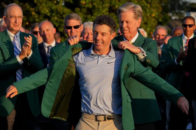 Augusta National Golf Club chairman Fred Ridley places the green jacket on Rory McIlroy during the green jacket ceremony after the final round of the Masters Tournament at Augusta National Golf Club on April 12, 2026.