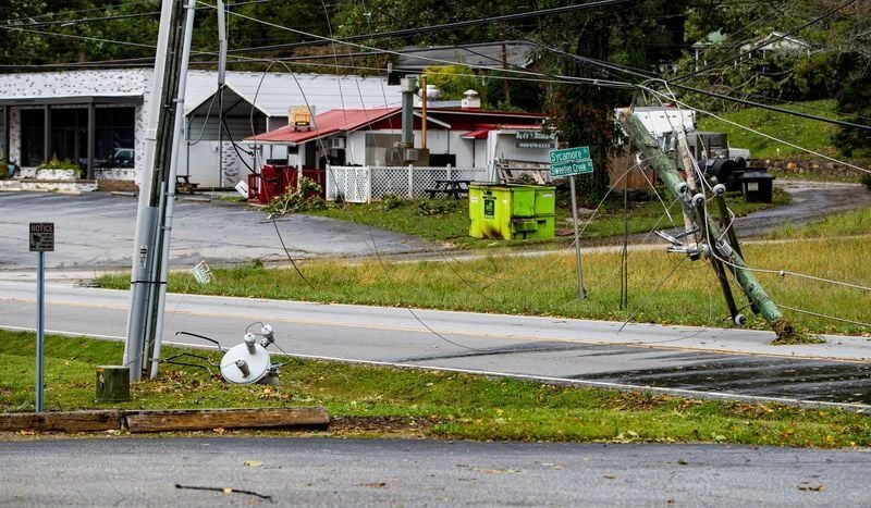 Downed power lines and poles line Sweeten Creek Road in Arden on Sept. 27, 2024 after Tropical Storm Helene passed through the area.