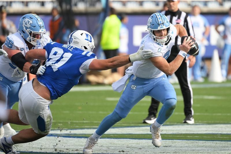 Oct 17, 2026; Durham, North Carolina, USA;  North Carolina Tar Heels quarter back Billy Edwards Jr. (9) runs the ball against Duke Blue Devils defensive tackle Owen Wafle (91) during the first quarter at Wallace Wade Stadium.  Mandatory Credit: Zachary ...