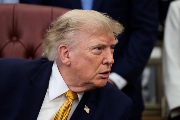 U.S. President Donald Trump signs an executive order in the Oval Office at the White House in Washington
