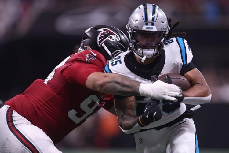 Sep 20, 2026; Atlanta, Georgia, USA;  Carolina Panthers running back Jonathon Brooks (25) rushes as Atlanta Falcons defensive end LaCale London (94) tackles during the third quarter at Mercedes-Benz Stadium.  Mandatory Credit: Brett Davis-Imagn Images