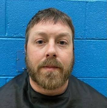 Marion man charged with shooting into business