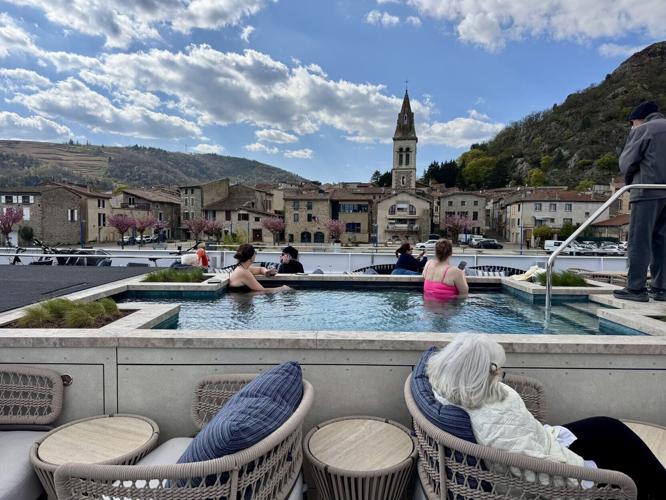 A couple of passengers soak in the ship's pool while soaking up views of Andance, a pretty village on the Rhone.