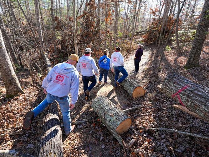 Drake Fowler, executive director of the North Carolina Arboretum in Asheville, takes a member of FEMA and a group from the U.S. Army Corps of Engineers around the forest grounds to look at the damage left from Tropical Storm Helene, on Nov. 16, 2024.
