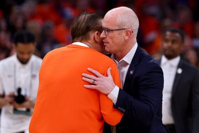 Connecticut head coach Dan Hurley, right, embraces Illinois head coach Brad Underwood prior to the Elite Eight round of the NCAA Tournament at TD Garden on March 30, 2024, in Boston.