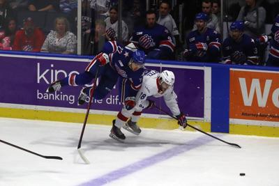 Rochester Amerks JJ Peterka (77) gets checked and goes over Laval's Danick Martel (18)
