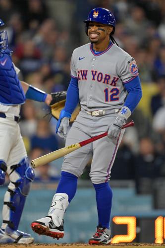 New York Mets shortstop Francisco Lindor (12) reacts to striking out against the Los Angeles Dodgers during the third inning at Dodger Stadium.