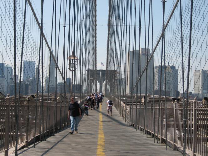 Walking across Brooklyn Bridge.
