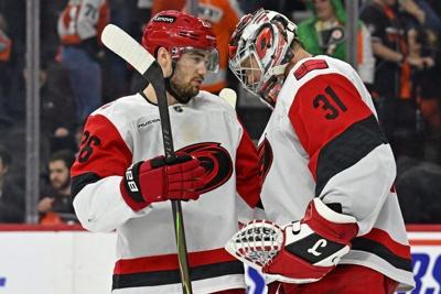 May 7, 2026; Philadelphia, Pennsylvania, USA; Carolina Hurricanes defenseman Sean Walker (26) and goaltender Frederik Andersen (31) celebrate win against the Philadelphia Flyers in game three of the second round of the 2026 Stanley Cup Playoffs at Xfini...