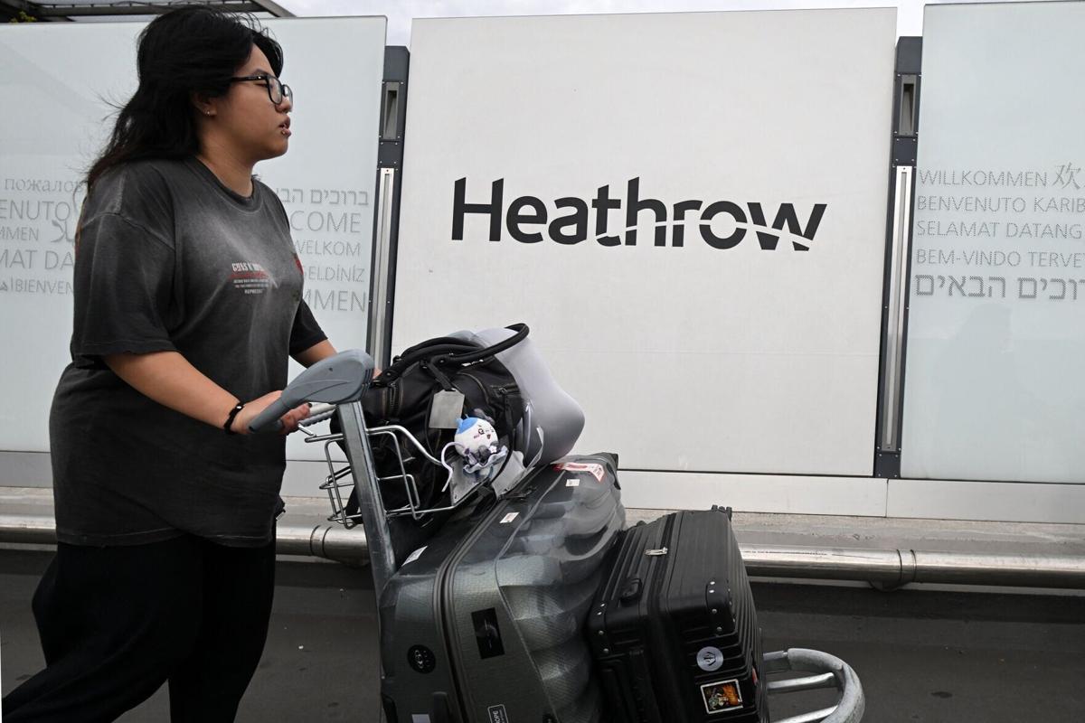 A traveller leaves the terminal at Heathrow Airport, west of London on Sept. 20, 2025.
