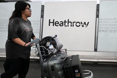 A traveller leaves the terminal at Heathrow Airport, west of London on Sept. 20, 2025.