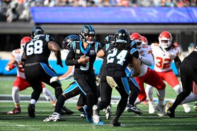 Nov 24, 2024; Charlotte, North Carolina, USA; Carolina Panthers quarterback Bryce Young (9) hands the ball off to running back Jonathon Brooks (24) in the second quarter at Bank of America Stadium. Mandatory Credit: Bob Donnan-Imagn Images
