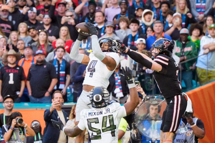 Oregon defensive back Brandon Finney Jr. hauls in an interception during his team's game against Texas Tech in the 2025 College Football Playoff in the Orange Bowl.