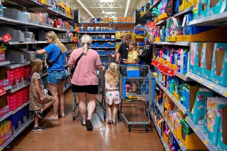 People shop for school supplies inside a Walmart in Edmond, Okla., Tuesday, July 30, 2024.
