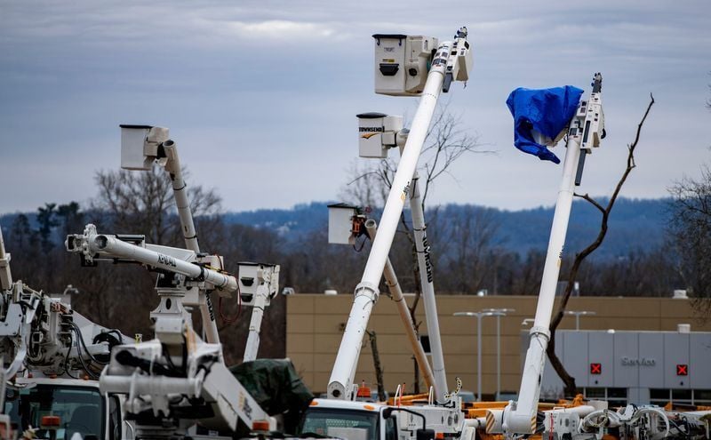 Utility trucks are staged at the WNC Agricultural Center on Jan. 24, 2026, as crews prepare to respond to potential power outages ahead of the winter storm in Western North Carolina.