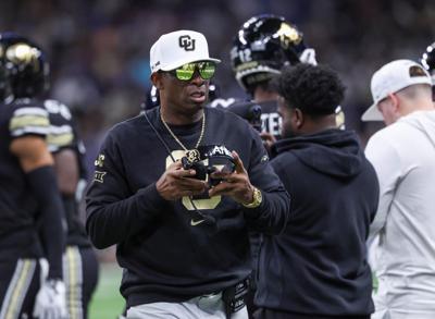 Dec 28, 2024; San Antonio, TX, USA; Colorado Buffaloes head coach Deion Sanders walks on the field between plays during the first quarter against the Brigham Young Cougars at Alamodome. Mandatory Credit: Troy Taormina-Imagn Images