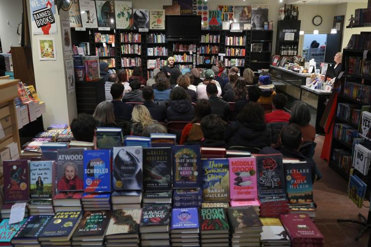 Librarian and author Jarrett Dapier, center, sits for a conversation with Chicago Teachers Union project organizer and former teacher Nora Flanagan about his graphic novel, "Wake Now in the Fire," at The Book Cellar, 4736 N. Lincoln Ave., Tuesday, Feb. ...