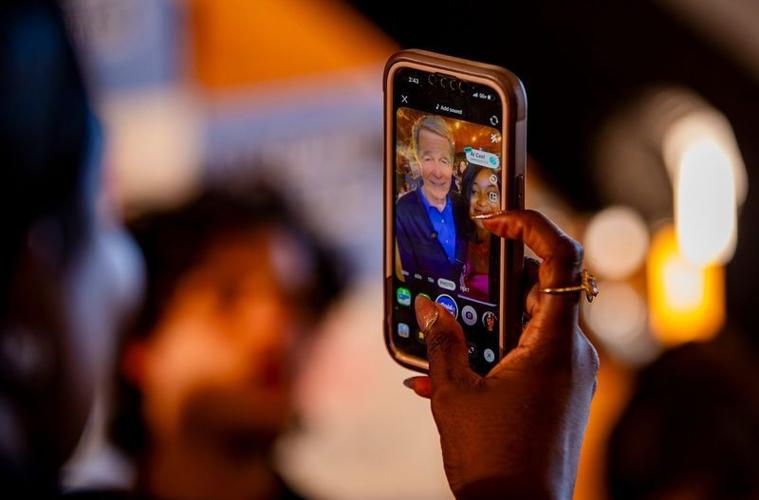 An attendee takes a selfie with former North Carolina Gov. Roy Cooper following his “Make Stuff Cost Less” event at Oklawaha Brewing Company in Hendersonville on Aug. 20, 2026.