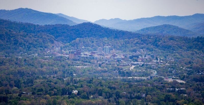 A view from Deaverview Mountain shows downtown Asheville in the distance on Monday, April 13, 2026. Buncombe County recently closed on the 342-acre property, which is slated to become a public park.