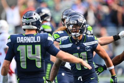 Nov 9, 2025; Seattle, Washington, USA; Seattle Seahawks wide receiver Jaxon Smith-Njigba (11) celebrates with Seattle Seahawks quarterback Sam Darnold (14) after scoring a touchdown during the first quarter against the Arizona Cardinals at Lumen Field.