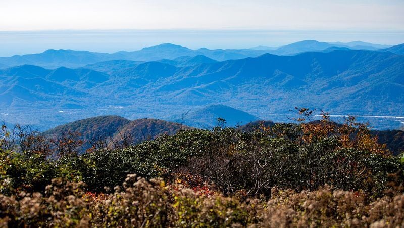 Layers of Blue Ridge Mountains stretch into the distance as fall colors begin to emerge near Craggy Gardens on Oct. 9, 2025.