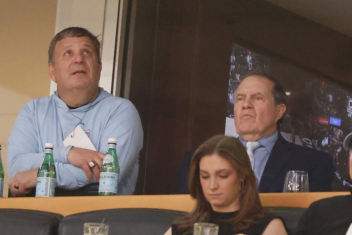 Head football coach Bill Belichick of the North Carolina Tar Heels looks on with general manager Michael Lombardi during the second half between the Chicago Bulls and the Denver Nuggets at the United Center on Jan. 27, 2025, in Chicago, Illinois.