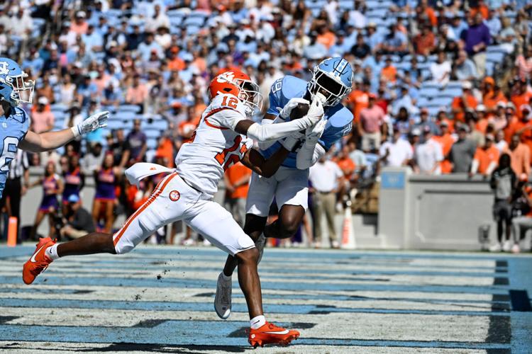 Oct 4, 2025; Chapel Hill, North Carolina, USA; Clemson Tigers wide receiver Bryant Wesco Jr. (12) attempts to catch a pass in the end zone as North Carolina Tar Heels defensive back Marcus Allen (29) defends in the first quarter at Kenan Stadium. Mandatory