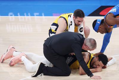 Tyrese Haliburton of the Indiana Pacers sustains an injury during the first quarter as Shai Gilgeous-Alexander of the Oklahoma City Thunder checks on him in Game 7 of the 2025 NBA Finals at Paycom Center on Sunday, June 22, 2025, in Oklahoma City, Oklah...