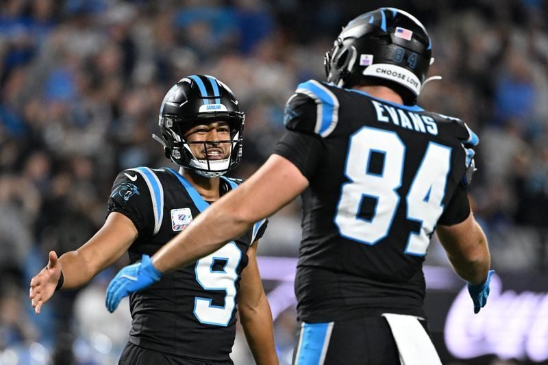 Oct 4, 2026; Charlotte, North Carolina, USA;  Carolina Panthers quarterback Bryce Young (9) and tight end Mitchell Evans (84) celebrate after a touchdown by running back Chuba Hubbard (not pictured) during the third quarter at Bank of America Stadium.  ...
