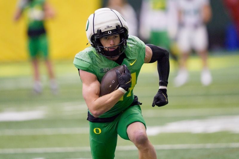 Oregon defensive back Dillon Thieneman carries the ball as the Oregon Ducks practice on Jan. 5, 2025, at the Moshofsky Center in Eugene, Oregon, ahead of the Peach Bowl.