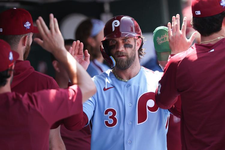 Philadelphia Phillies first baseman Bryce Harper high fives in the dugout after scoring during the fourth inning against the San Diego Padres at Citizens Bank Park on June 4, 2026.
