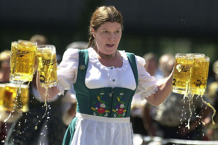 CINCINNATI- SEPTEMBER 17: Annamarie Harten competes in a beer stein race as part of the Gemuetlichkeit Games held as a promotion for Oktoberfest Zinzinnati September 17, 2003 in Cincinnati. Competitors carry 6 beer 1- liter beer steins, which weigh abou...