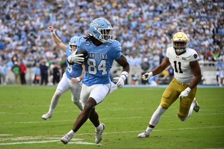 Oct 3, 2026; Chapel Hill, North Carolina, USA; North Carolina Tar Heels tight end Shamar Easter (84) scores a touchdopwn as Notre Dame Fighting Irish defensive lineman Keon Keeley (11) defends in the first quarter at Kenan Stadium. Mandatory Credit: Bob...