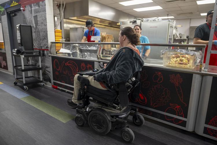 Erica Carter makes her way through the cafeteria at the Omaha Nation Public Schools campus, where she works as a finance manager.