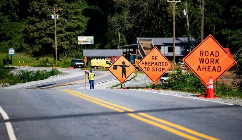 Roadwork signs line U.S. 64/74A as reconstruction continues following damage from Tropical Storm Helene on July 30, 2026, in Chimney Rock.