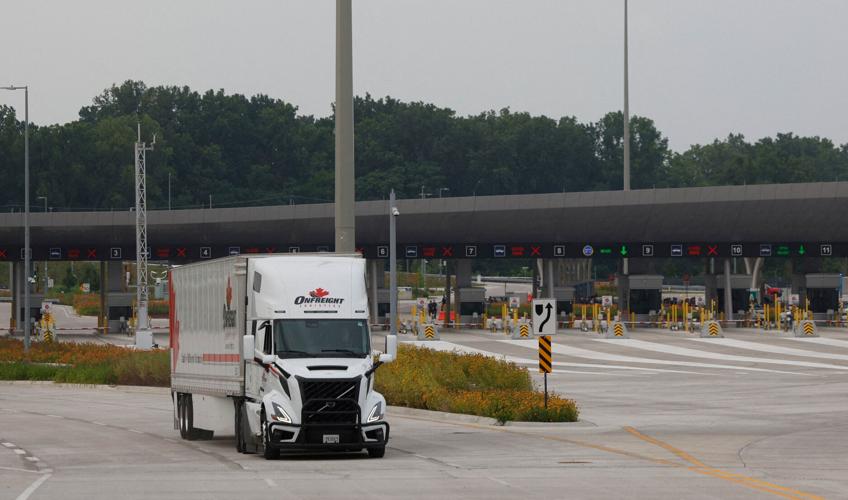 FILE PHOTO: The first commercial truck, hauling auto parts, crosses the Gordie Howe International Bridge that connects Windsor, Ontario to Detroit, Michigan, in Windsor